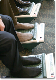 Attendees get their feet massaged while waiting for their chair massage